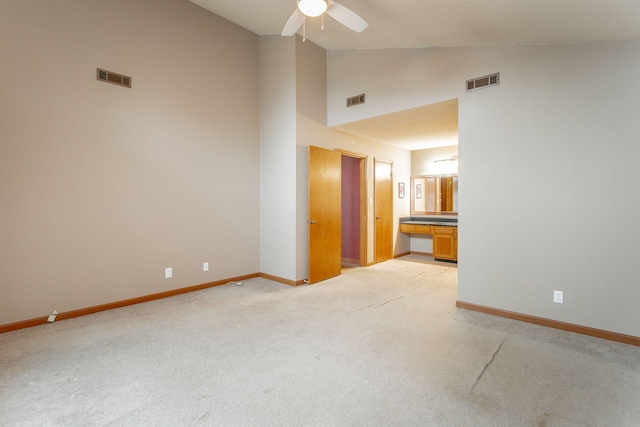 empty room featuring light colored carpet, visible vents, and baseboards