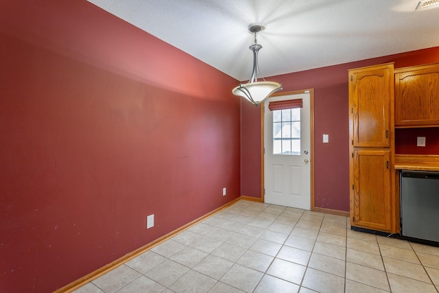 unfurnished dining area with light tile patterned flooring and baseboards