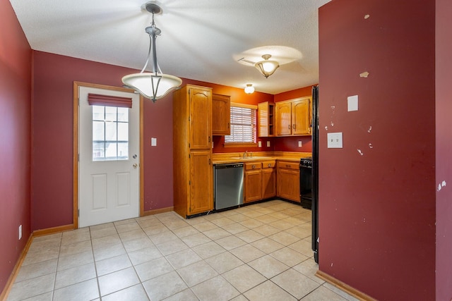 kitchen featuring dishwasher, light tile patterned floors, decorative light fixtures, and brown cabinets