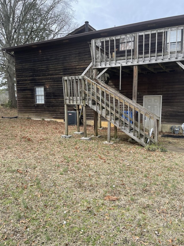 rear view of property with central air condition unit, stairs, and a deck