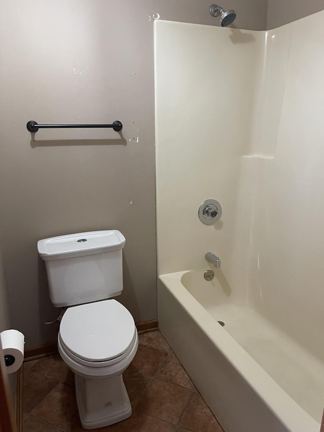 full bathroom with baseboards, tub / shower combination, toilet, and tile patterned floors