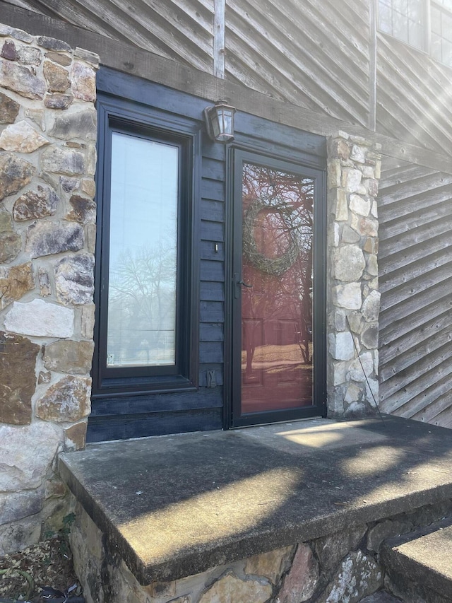 entrance to property with stone siding