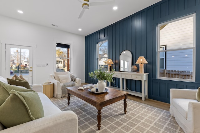 living room featuring light hardwood / wood-style flooring and ceiling fan