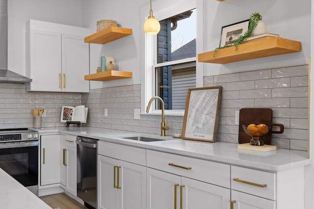 kitchen with white cabinetry, sink, electric range, light stone counters, and wall chimney exhaust hood