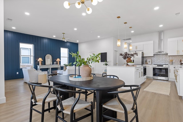 dining room with ceiling fan and light hardwood / wood-style flooring