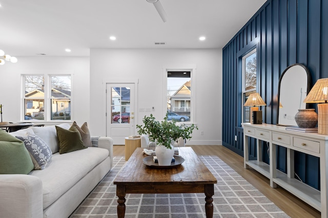 living room with hardwood / wood-style floors and a chandelier