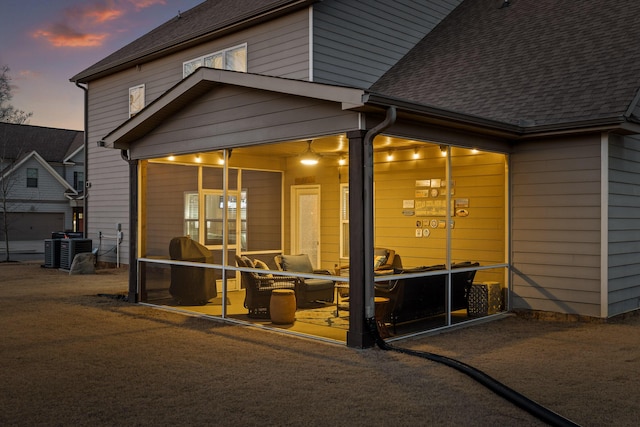 exterior space featuring a sunroom and central air condition unit