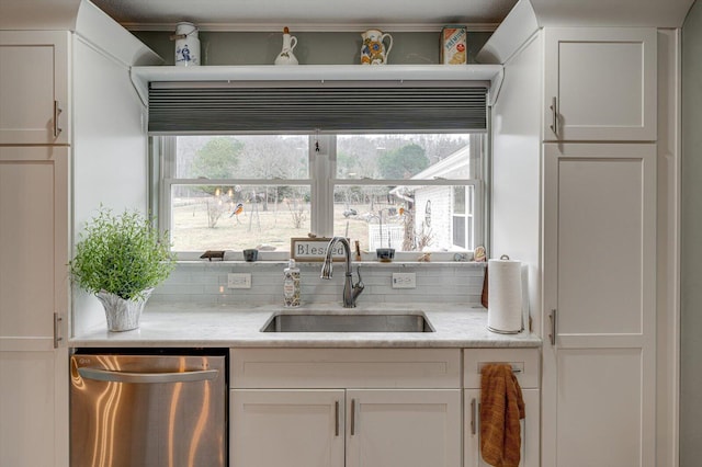 kitchen with a healthy amount of sunlight, sink, white cabinets, and dishwasher