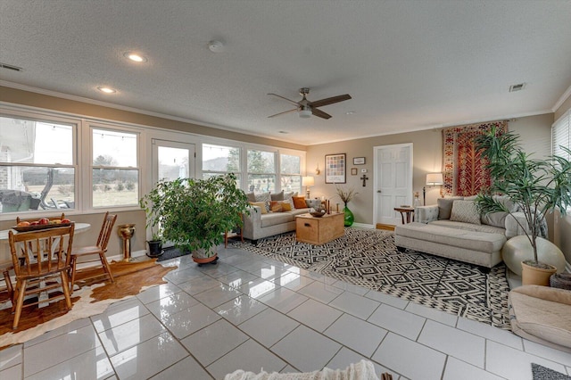 tiled living room with crown molding, ceiling fan, a textured ceiling, and a healthy amount of sunlight