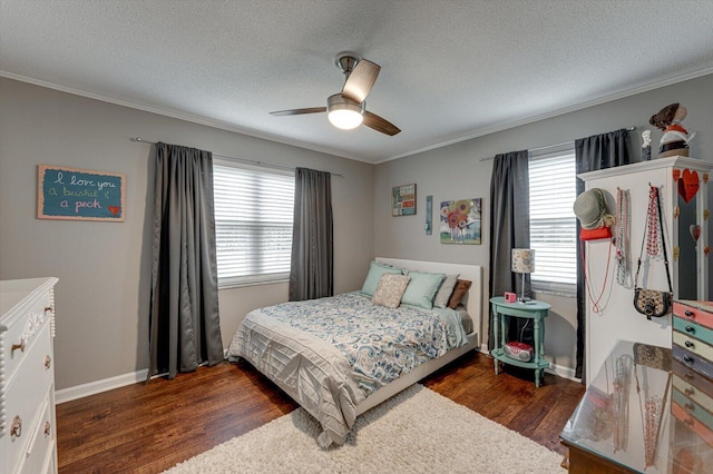 bedroom with crown molding, dark wood-type flooring, ceiling fan, and a textured ceiling