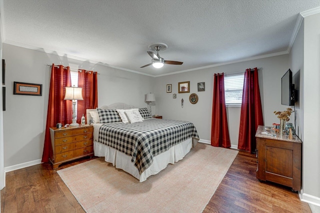 bedroom featuring ceiling fan, crown molding, dark hardwood / wood-style floors, and a textured ceiling