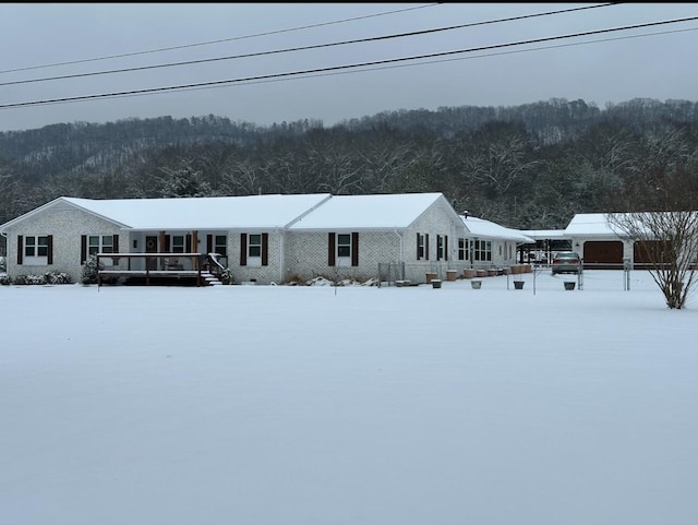 view of snow covered back of property