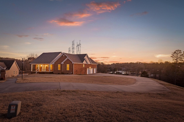 view of front of property featuring a yard and a garage