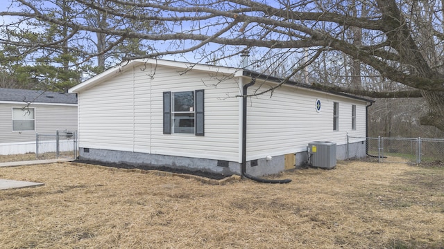 view of home's exterior featuring a yard and central AC unit