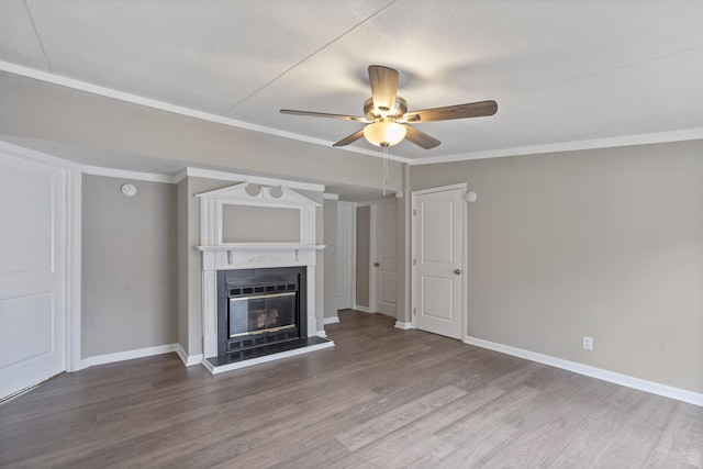 unfurnished living room featuring hardwood / wood-style flooring, ornamental molding, and ceiling fan