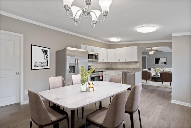 dining room featuring crown molding, ceiling fan with notable chandelier, and hardwood / wood-style floors