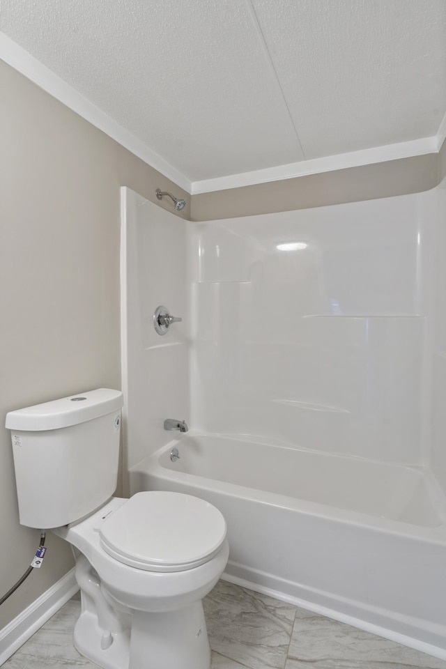 bathroom with shower / washtub combination, toilet, and a textured ceiling