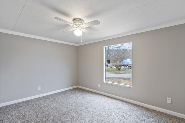 carpeted empty room featuring ceiling fan and a textured ceiling