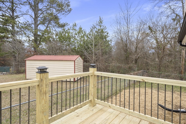 wooden terrace featuring a yard and a storage unit