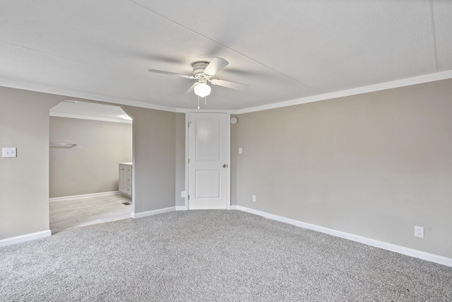 carpeted empty room with ornamental molding, a textured ceiling, and ceiling fan