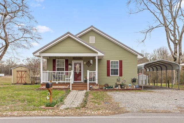 bungalow featuring a front lawn, an outbuilding, and a storage shed