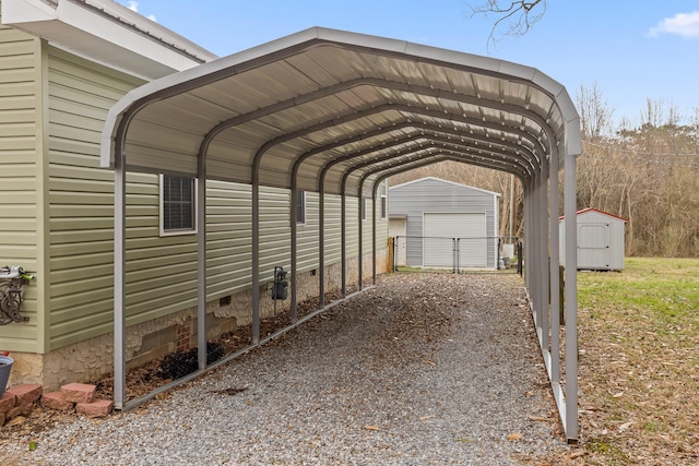 view of parking / parking lot with a carport, a storage unit, gravel driveway, and fence