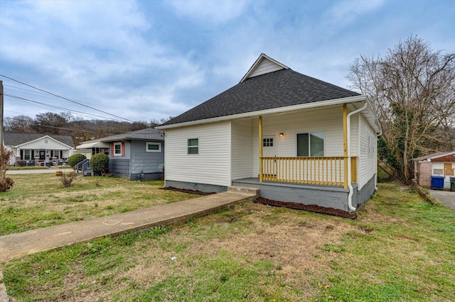 bungalow-style house featuring a front yard and covered porch