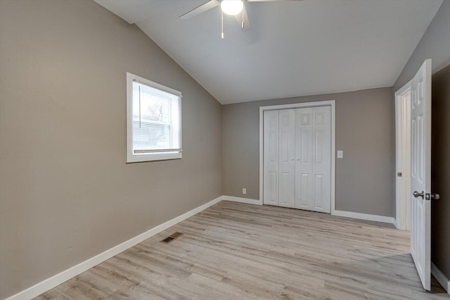 unfurnished bedroom featuring vaulted ceiling, ceiling fan, light hardwood / wood-style floors, and a closet