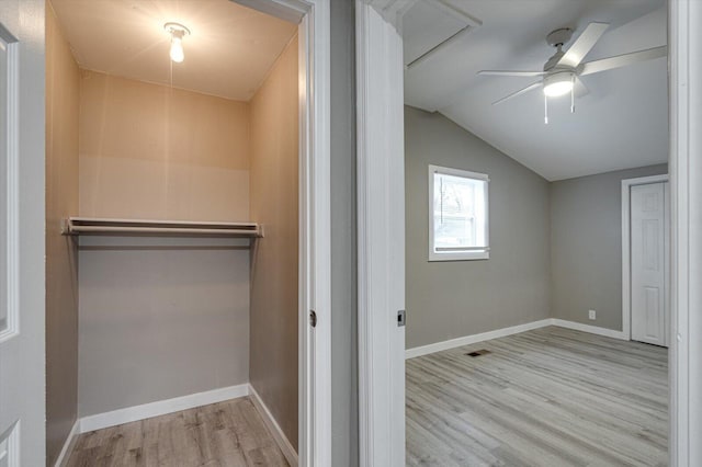 additional living space featuring lofted ceiling, ceiling fan, and light wood-type flooring