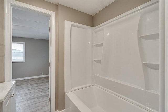 bathroom with vanity, shower / bath combination, and hardwood / wood-style floors