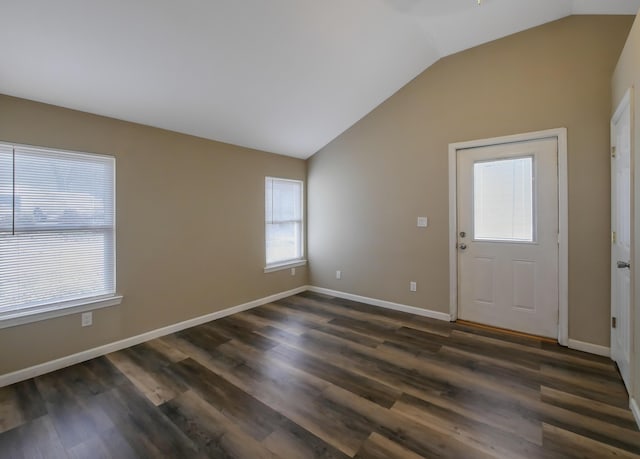 entryway with dark hardwood / wood-style floors and vaulted ceiling