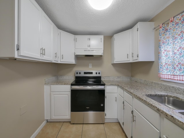 kitchen featuring white cabinetry, light tile patterned floors, and stainless steel range with electric cooktop