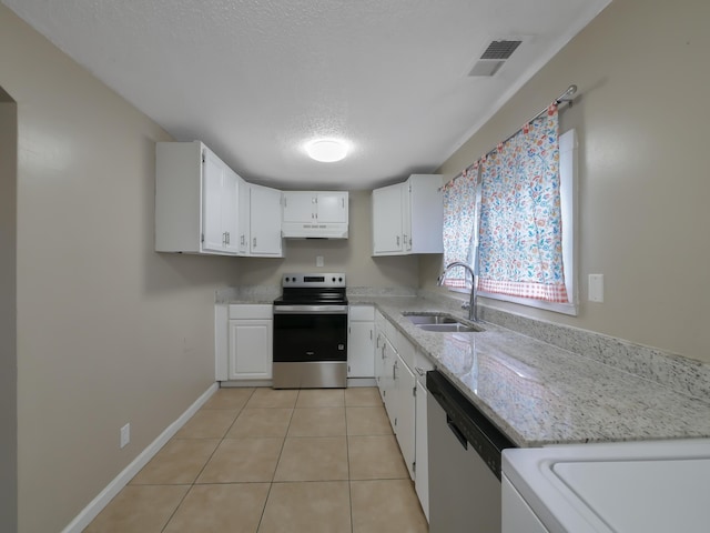 kitchen featuring appliances with stainless steel finishes, sink, white cabinets, light tile patterned floors, and light stone countertops