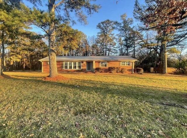 ranch-style home with a front lawn