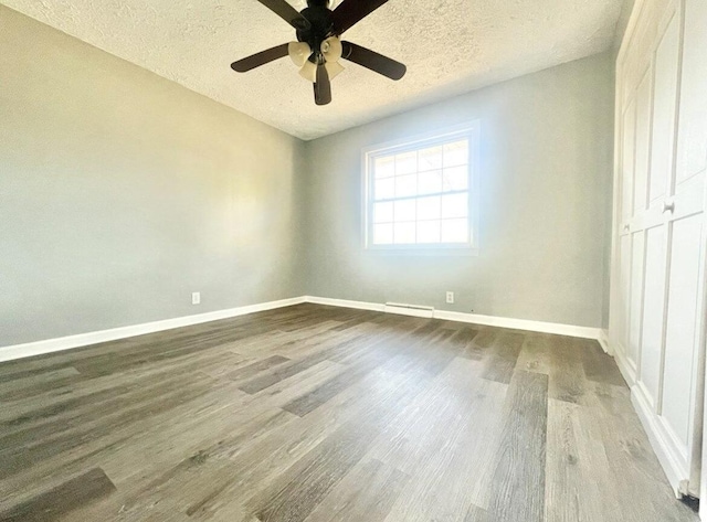 spare room with ceiling fan, hardwood / wood-style floors, and a textured ceiling