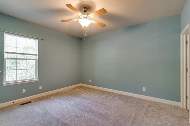 empty room with light colored carpet and ceiling fan