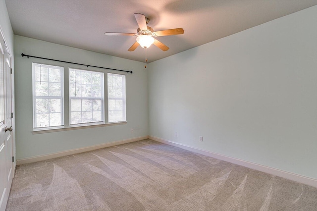 carpeted spare room with ceiling fan and a wealth of natural light