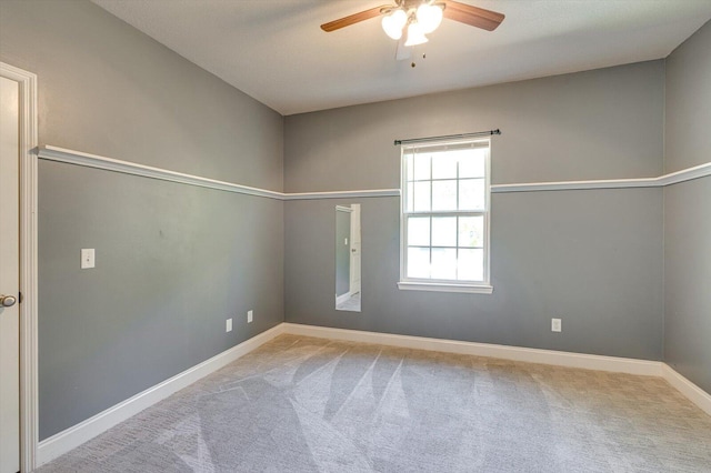 spare room featuring ceiling fan and light colored carpet