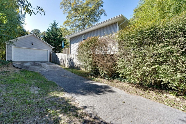 view of side of home featuring a garage and an outdoor structure