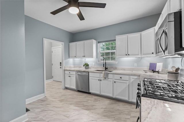 kitchen with sink, stainless steel appliances, white cabinets, and ceiling fan