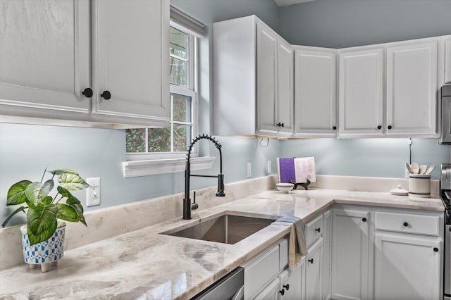 kitchen featuring white cabinetry, light stone countertops, sink, and stainless steel dishwasher