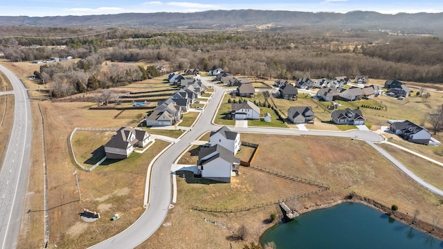 birds eye view of property with a water and mountain view