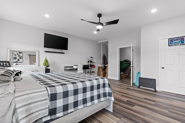 bedroom with dark hardwood / wood-style flooring and ceiling fan