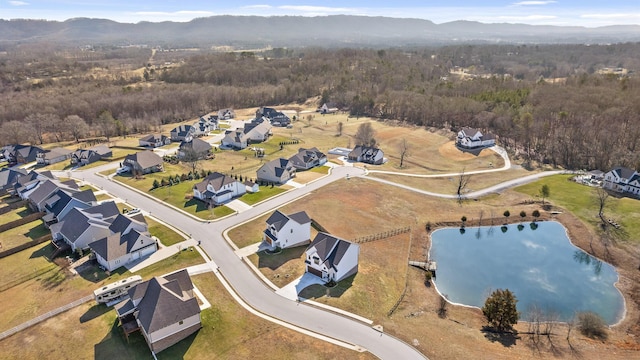 birds eye view of property featuring a water and mountain view