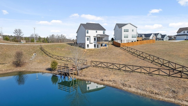 rear view of house featuring a water view