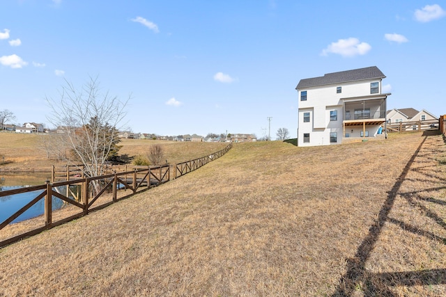 view of yard featuring a rural view and a sunroom