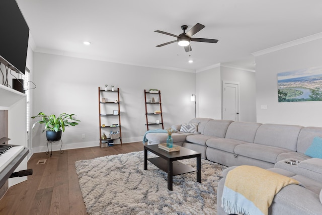 living room with ornamental molding, dark hardwood / wood-style floors, and ceiling fan