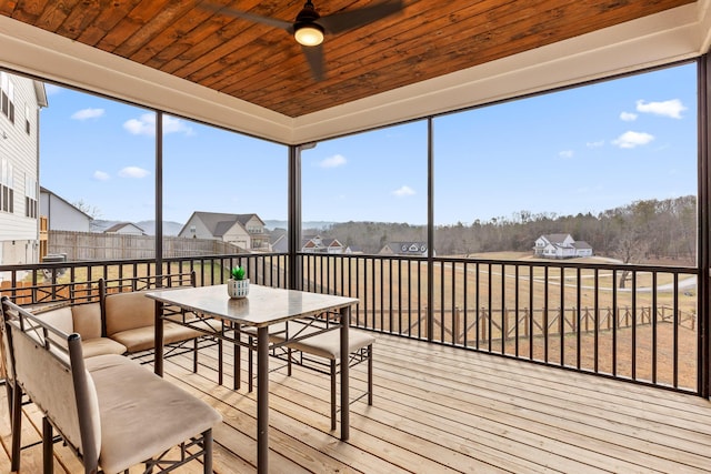 unfurnished sunroom with wooden ceiling and ceiling fan