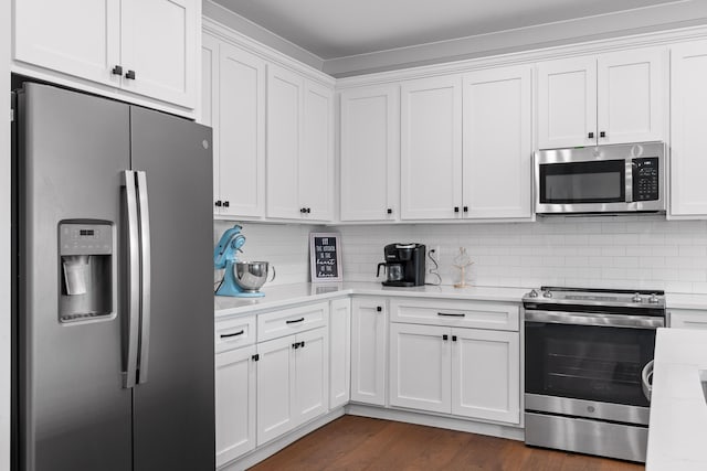 kitchen featuring white cabinetry, appliances with stainless steel finishes, dark hardwood / wood-style flooring, and backsplash