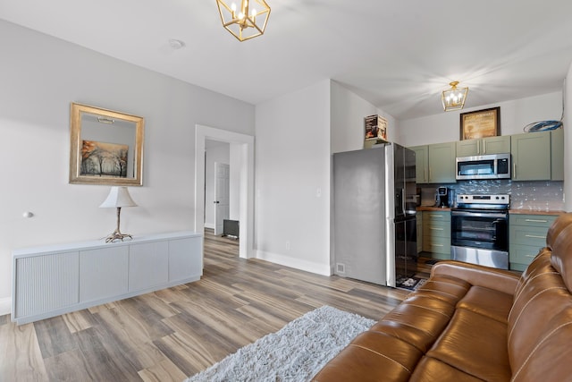 living room featuring light hardwood / wood-style floors and a notable chandelier